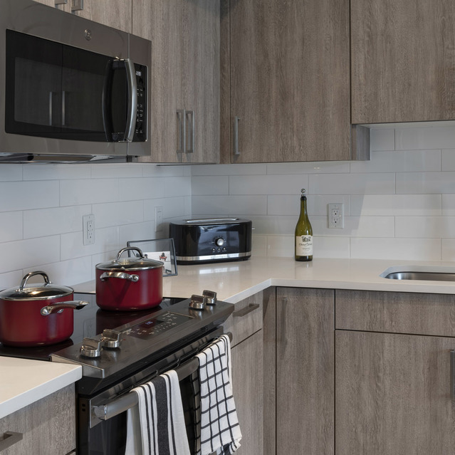 Blu27 - Stylish Kitchen with Wooden Cabinets and Black Appliances